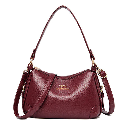 Women’s one-shoulder messenger bag in wine red soft leather with gold-tone hardware.