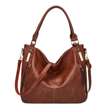 Brown leather-look hobo tote with top handles, crossbody strap, and zip pockets