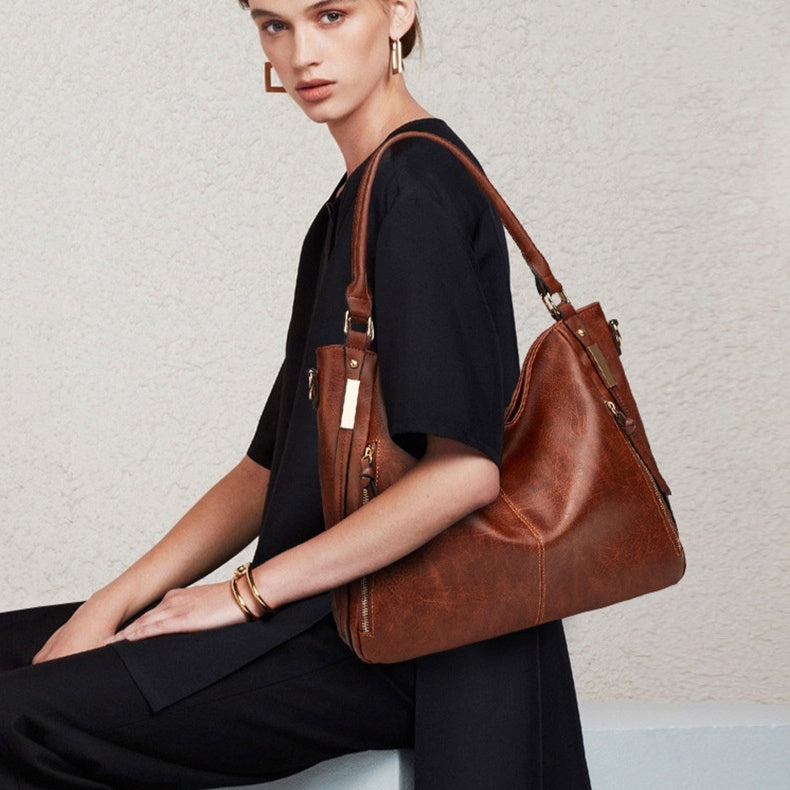 Large brown leather-look tote shoulder bag with top handles and side zipper pockets