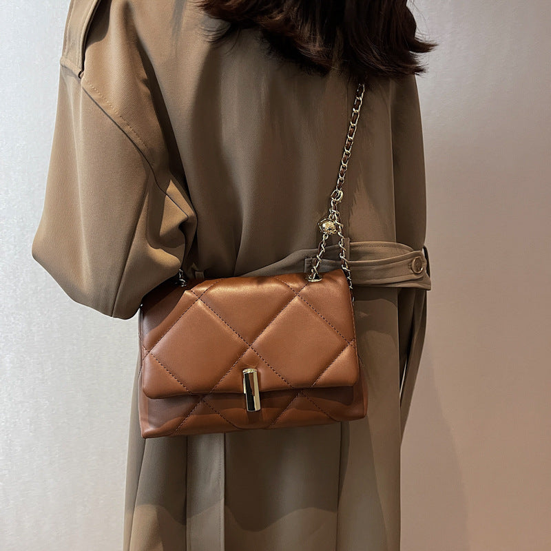 Brown quilted diamond messenger bag, gold chain strap and front bar clasp
