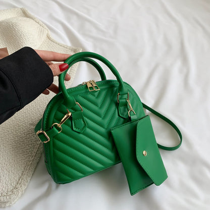 Green quilted women's shoulder messenger bag with top handle and crossbody strap