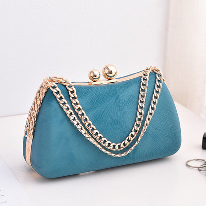 Blue textured clutch bag with gold-tone chain shoulder strap and kiss-lock clasp