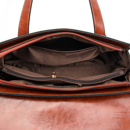 Handbag interior with brown fabric lining and zip pocket, shown with open top