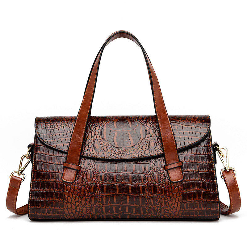 Medium brown croc-pattern hand carry shoulder bag with top handles and crossbody strap