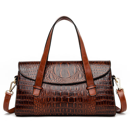 Medium brown croc-pattern hand carry shoulder bag with top handles and crossbody strap