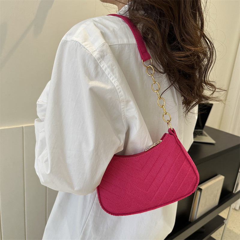 Felt crossbody bag, bright pink with gold chain strap and curved flap