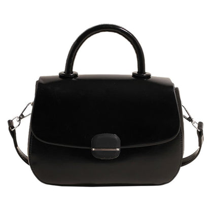 Black double-layer crossbody handbag with top handles, flap front, and side shoulder straps