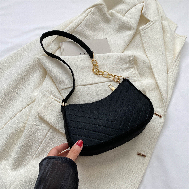 Black felt crossbody bag with gold chain strap and small flap front