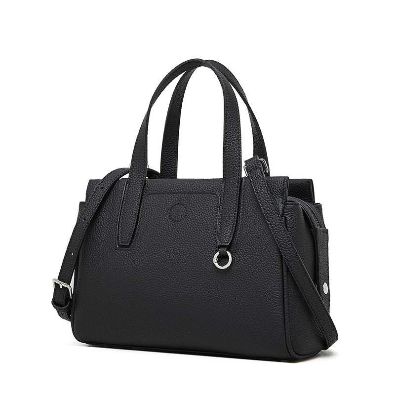 Black crossbody bag with top handles, front pocket, and adjustable shoulder strap