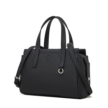 Black crossbody bag with top handles, front pocket, and adjustable shoulder strap