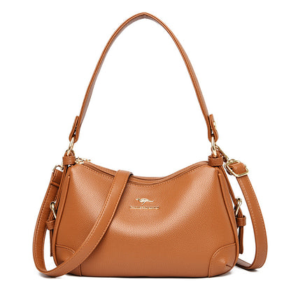 Women’s one-shoulder messenger bag in cognac brown soft leather with gold-tone hardware.
